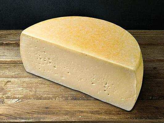 Greek Cheese Guide: 12 Traditional Varieties 5 Traditional Greek kefalotyri hard cheese wedge with a firm pale yellow texture